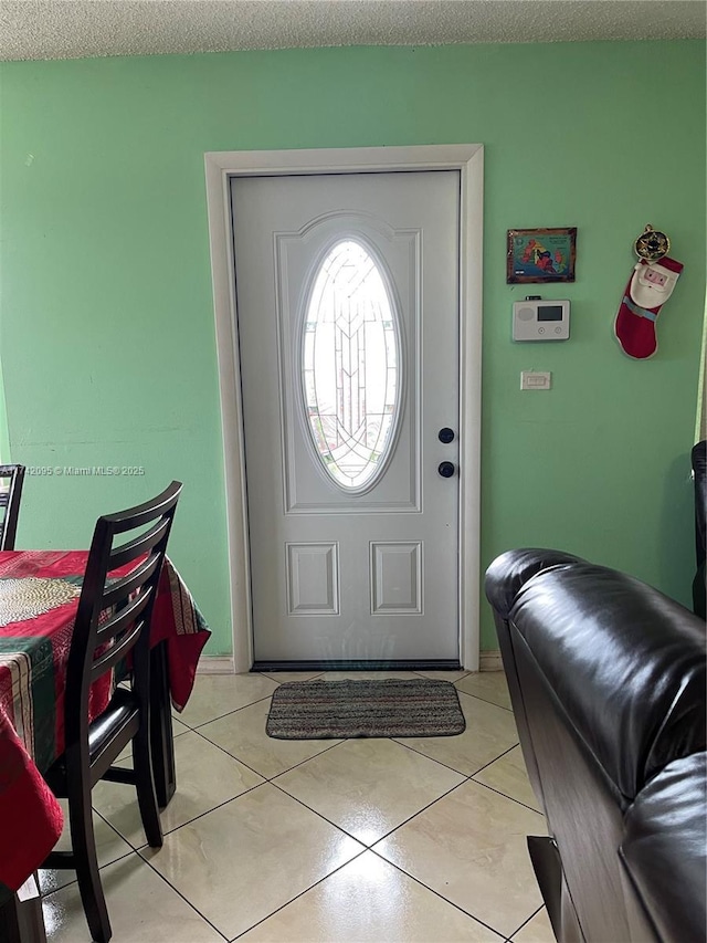 tiled entrance foyer with a textured ceiling