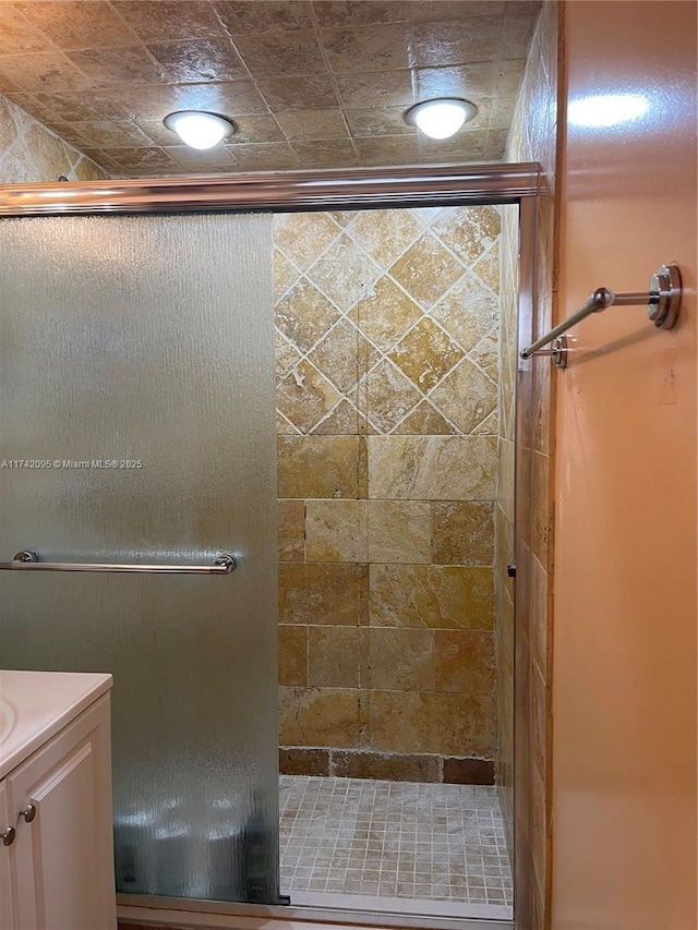 bathroom featuring an enclosed shower and vanity