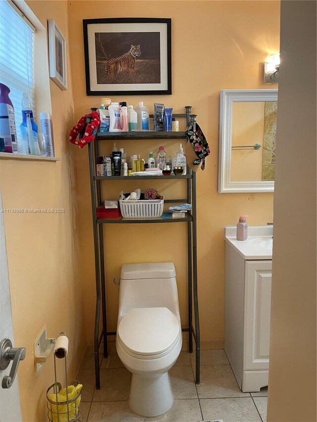 bathroom with vanity, tile patterned flooring, and toilet