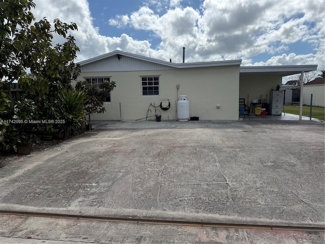 exterior space with a carport