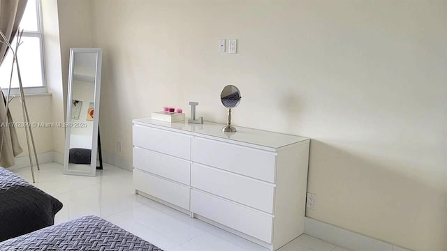 bedroom with light tile patterned floors