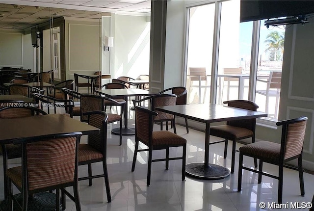 dining area with light tile patterned floors and a healthy amount of sunlight