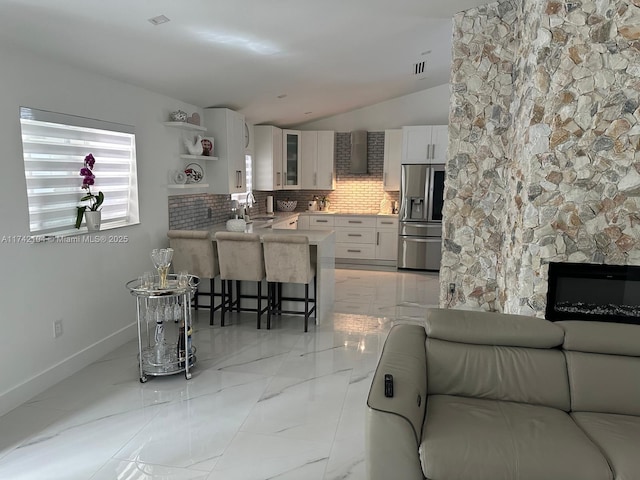 living room featuring vaulted ceiling and sink