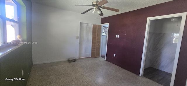 unfurnished bedroom with ceiling fan and a textured ceiling