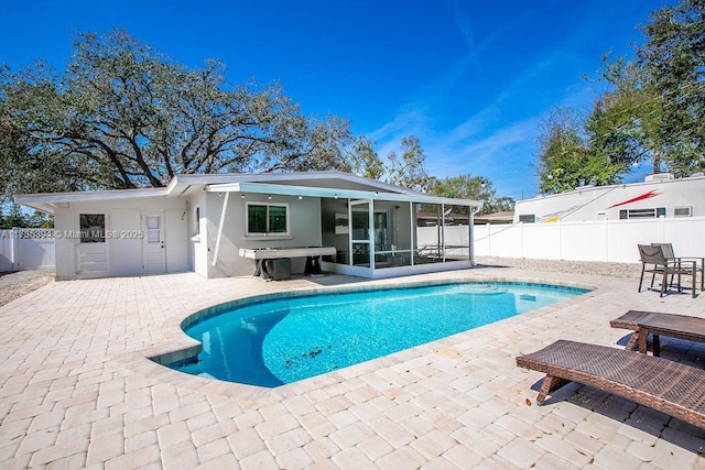 view of pool with a patio area, a fenced backyard, a sunroom, and a fenced in pool