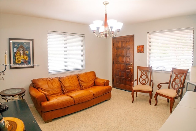 carpeted living room with an inviting chandelier