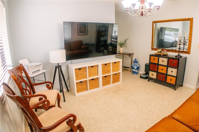 living area with a healthy amount of sunlight and a notable chandelier