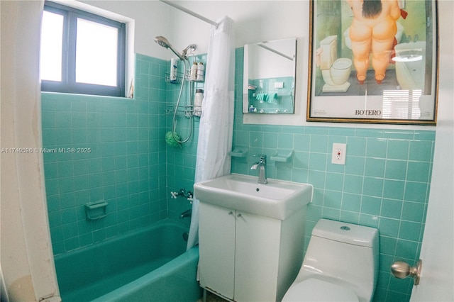 full bathroom with vanity, toilet, tile walls, and shower / bath combo with shower curtain