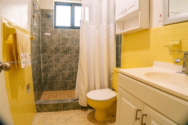 bathroom featuring vanity, tile walls, curtained shower, and toilet