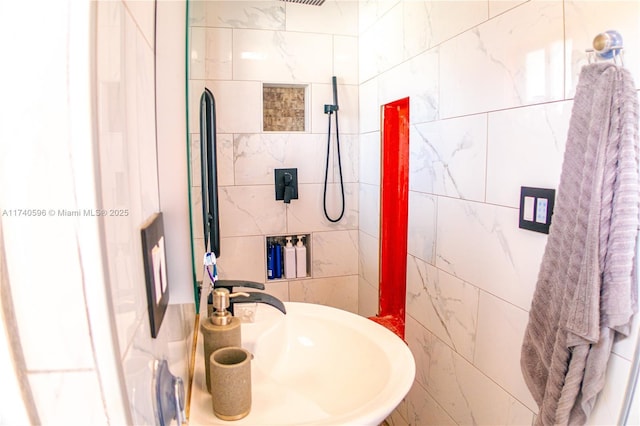 bathroom with sink and tile walls