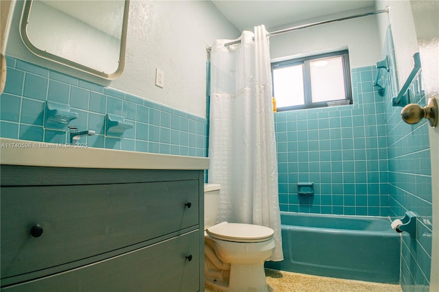 full bathroom featuring shower / bath combination with curtain, vanity, toilet, and tile walls