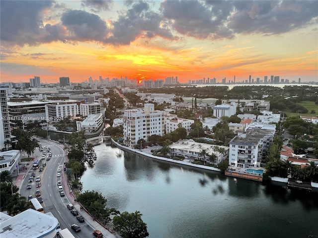 birds eye view of property featuring a water view and a city view