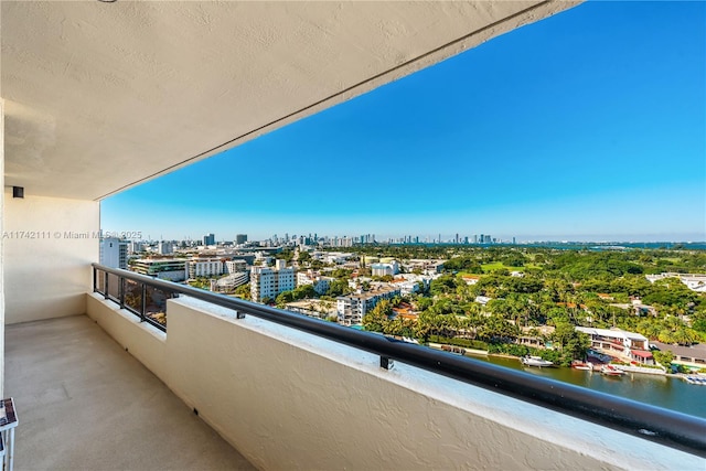 balcony with a view of city and a water view