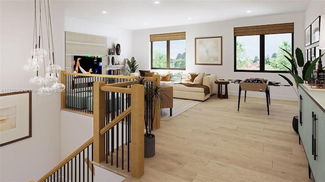 living area featuring baseboards, light wood-style flooring, and recessed lighting