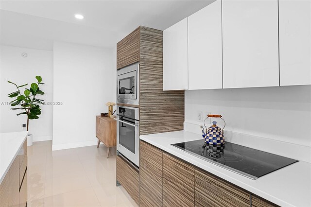 460 NE 28th St Unit 1404, Miami, FL 33137 - kitchen featuring appliances with stainless steel finishes, modern cabinets, white cabinetry, light countertops, and recessed lighting