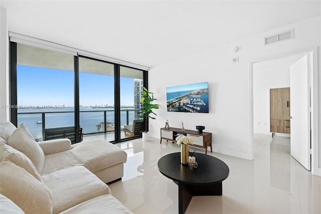 living room with floor to ceiling windows and a water view