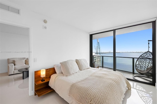 bedroom featuring floor to ceiling windows, a water view, access to outside, and light tile patterned floors