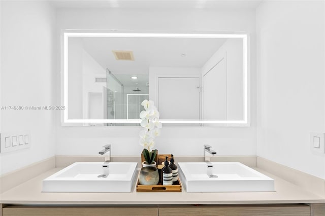 bathroom with vanity and a shower with shower door