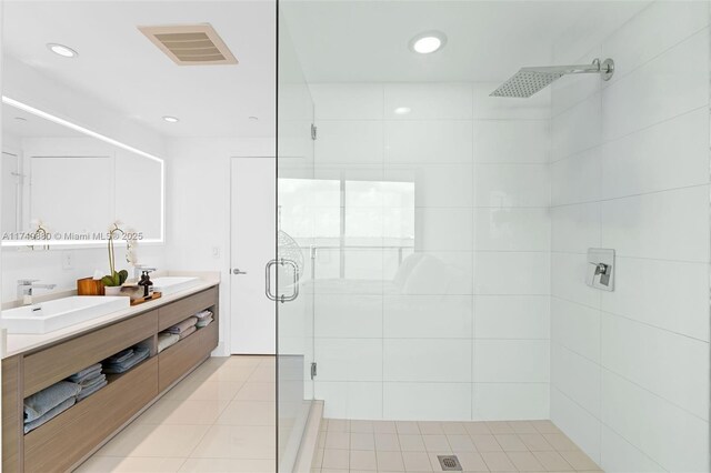 bathroom featuring vanity, an enclosed shower, and tile patterned floors