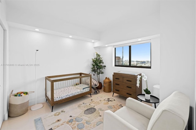 bedroom featuring a nursery area