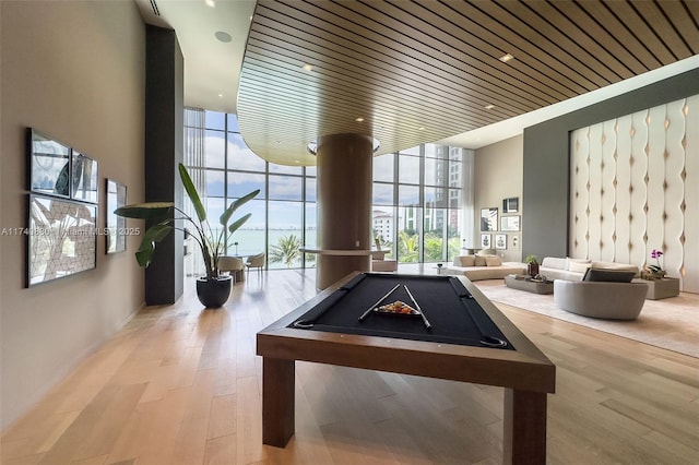 game room featuring billiards, light hardwood / wood-style floors, expansive windows, and wooden ceiling