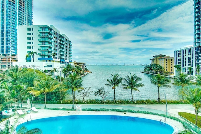 view of swimming pool with a water view