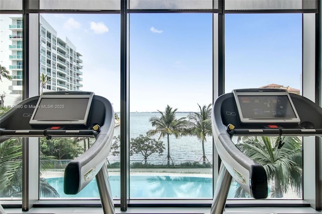 exercise room with a water view