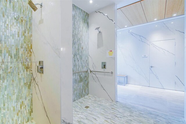 460 NE 28th St Unit 1404, Miami, FL 33137 - bathroom featuring a marble finish shower, recessed lighting, and tile walls