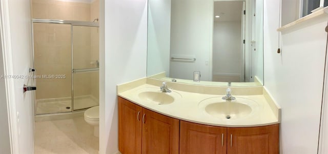 bathroom with vanity, toilet, and an enclosed shower