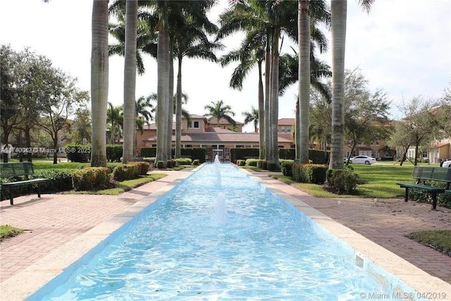 view of pool featuring a yard