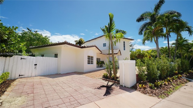 691 Ridgewood Rd, Key Biscayne, FL 33149 - exterior space with a tile roof, fence, a gate, and stucco siding