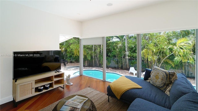 691 Ridgewood Rd, Key Biscayne, FL 33149 - living area featuring a healthy amount of sunlight and wood finished floors