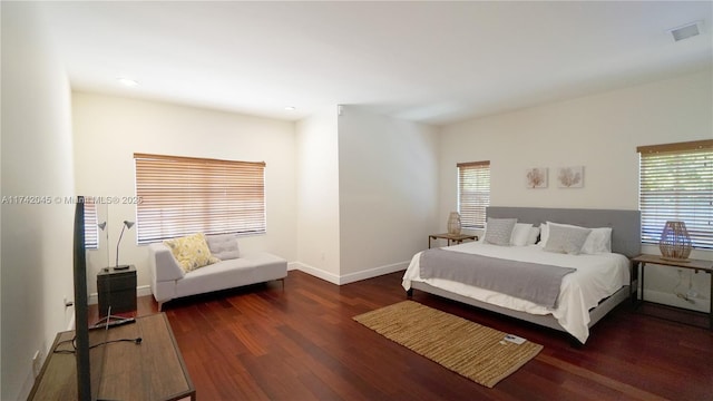 691 Ridgewood Rd, Key Biscayne, FL 33149 - bedroom with baseboards, wood finished floors, visible vents, and multiple windows