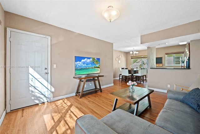 living room with a notable chandelier and hardwood / wood-style flooring