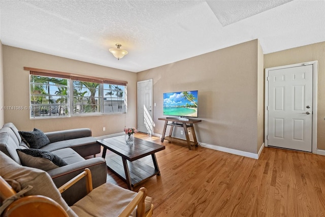 living room featuring light hardwood / wood-style floors and a textured ceiling