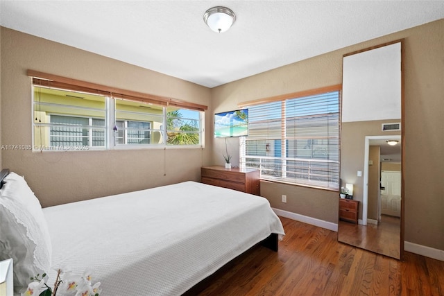 bedroom featuring dark hardwood / wood-style flooring