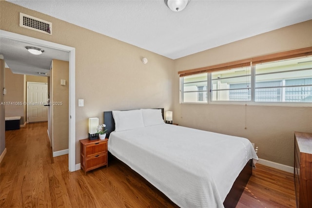 bedroom with wood-type flooring