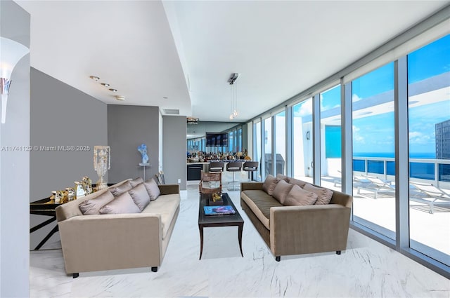 living room featuring expansive windows and a water view