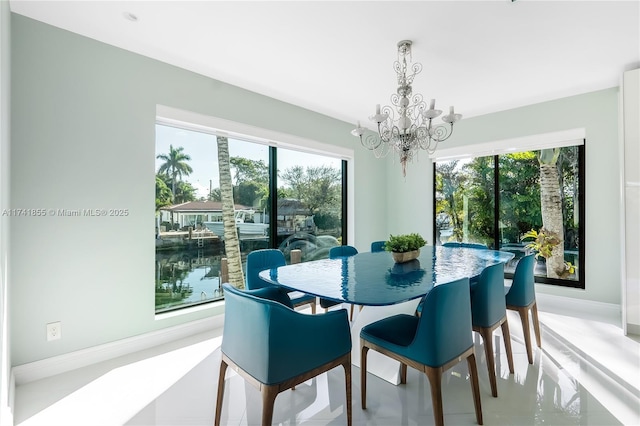 dining room with baseboards and a notable chandelier