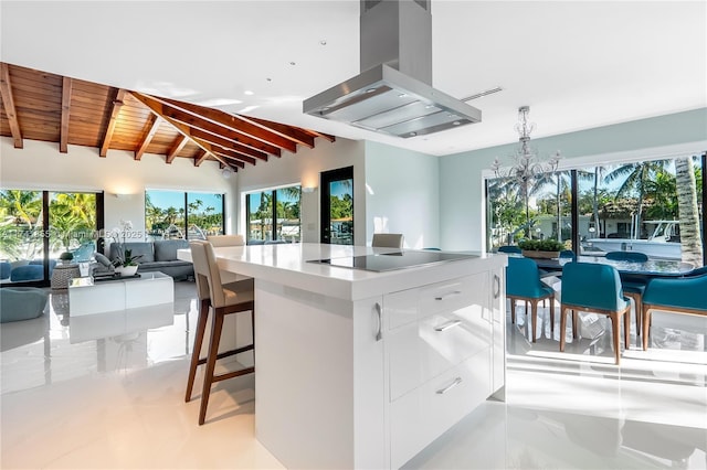 kitchen featuring vaulted ceiling with beams, island exhaust hood, white cabinets, black electric stovetop, and modern cabinets