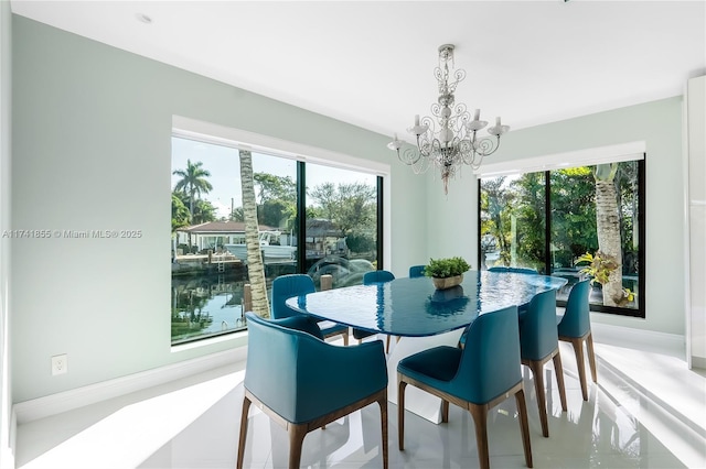 dining area with a notable chandelier and baseboards