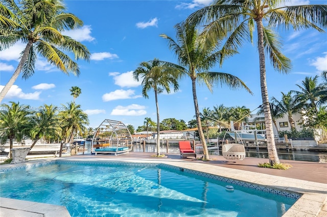 view of pool featuring boat lift and a boat dock