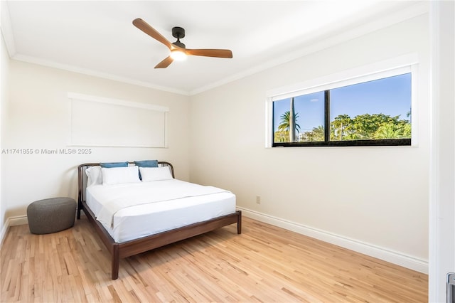 bedroom featuring a ceiling fan, baseboards, light wood-type flooring, and ornamental molding