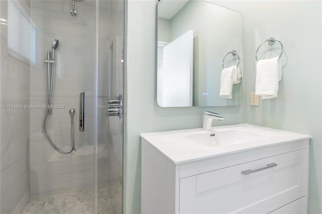 bathroom featuring a stall shower and vanity