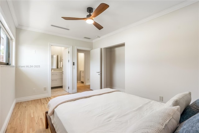 bedroom featuring connected bathroom, ornamental molding, ceiling fan, and light wood-type flooring