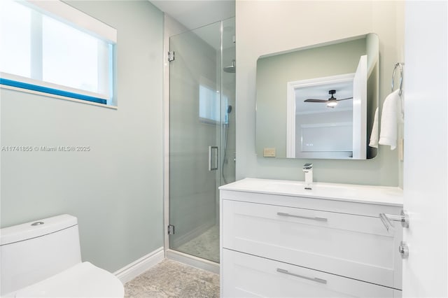 bathroom with vanity, a shower with door, and toilet