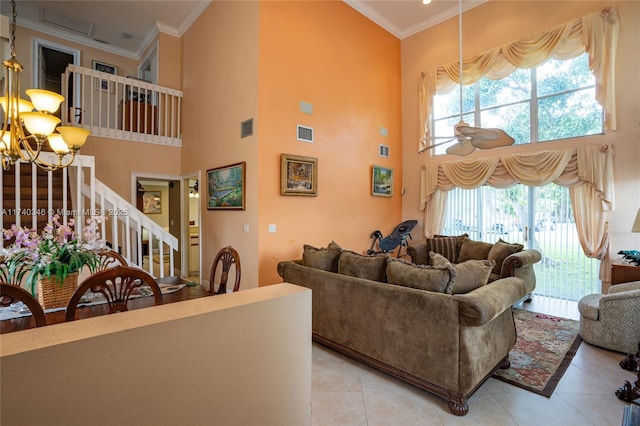 living room with stairway, ceiling fan with notable chandelier, visible vents, and ornamental molding