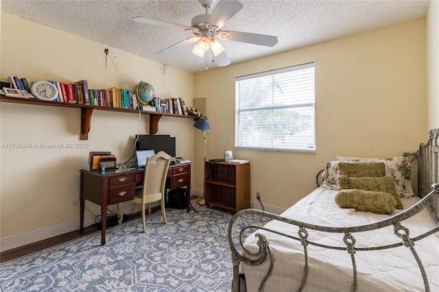 bedroom with ceiling fan and a textured ceiling