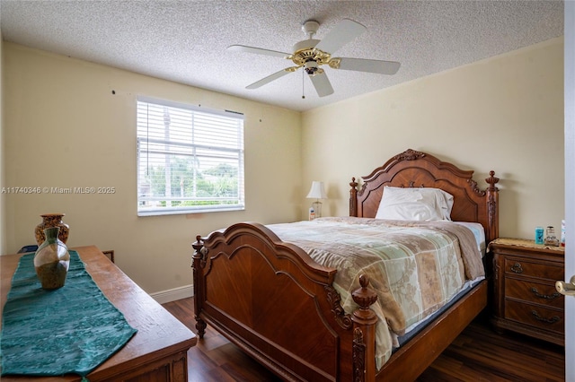 bedroom featuring ceiling fan, dark hardwood / wood-style floors, and a textured ceiling