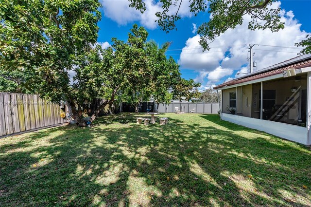 view of yard with a sunroom